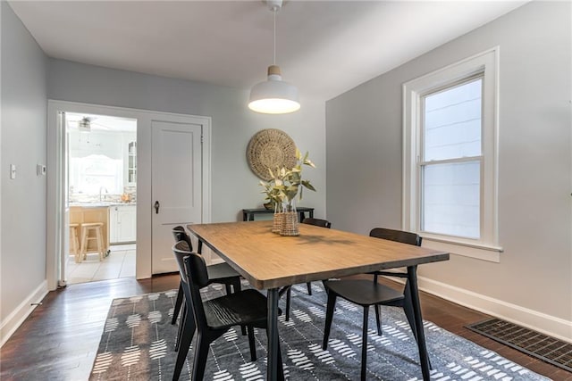 521 Tracy Ave, Kansas City, MO 64016 - dining space with dark wood-style floors and ceiling fan
