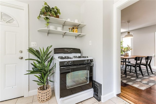 521 Tracy Ave, Kansas City, MO 64016 - kitchen featuring range with gas cooktop and light wood finished floors