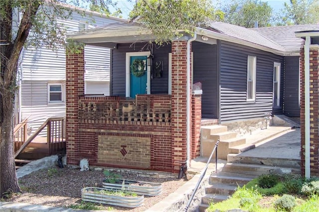 521 Tracy Ave, Kansas City, MO 64016 - view of front of home with brick siding, a garden, and stairway