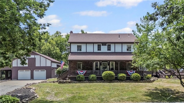 1124 S Locust St, Ottawa, KS 66067 - view of front of home with an outdoor structure, a garage, a front lawn, a chimney, and a porch