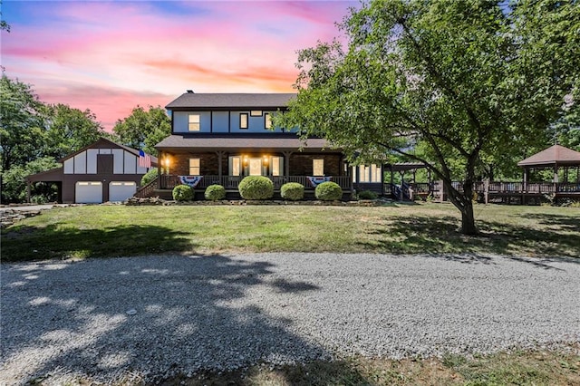 1124 S Locust St, Ottawa, KS 66067 - view of front of house featuring an outdoor structure, a garage, a porch, a gazebo, and a front yard