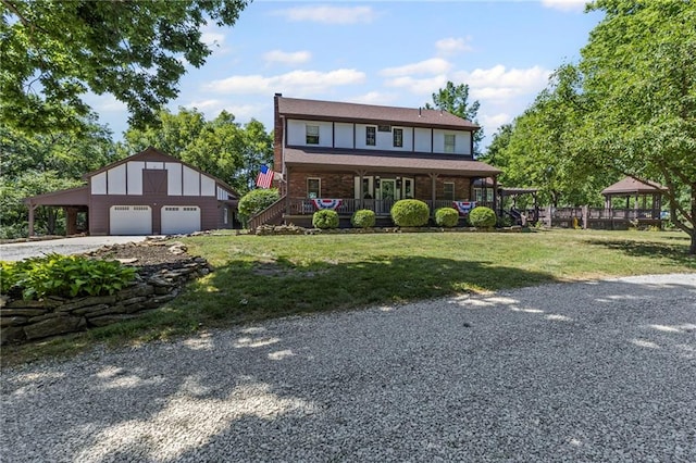 1124 S Locust St, Ottawa, KS 66067 - view of front facade with a detached garage, a front yard, an outbuilding, a gazebo, and driveway