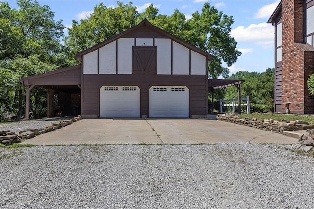 1124 S Locust St, Ottawa, KS 66067 - view of front of property with an outdoor structure, a detached garage, board and batten siding, and driveway