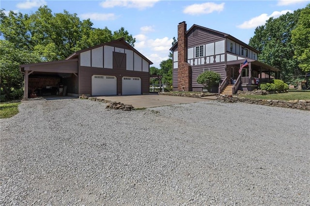 1124 S Locust St, Ottawa, KS 66067 - view of front of house with driveway, an outdoor structure, and a chimney