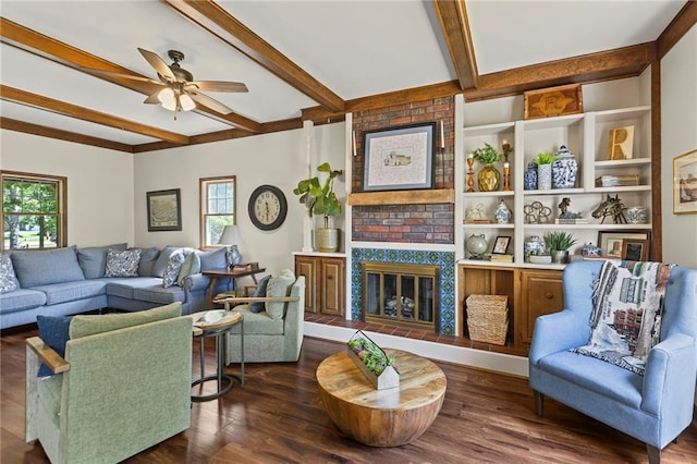 1124 S Locust St, Ottawa, KS 66067 - living area featuring healthy amount of natural light, beamed ceiling, ceiling fan, wood finished floors, and a fireplace