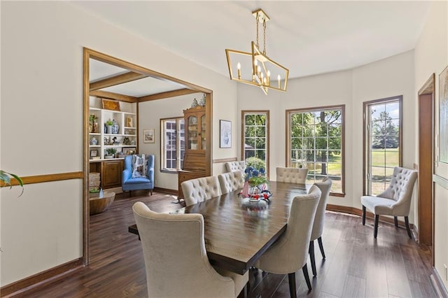 1124 S Locust St, Ottawa, KS 66067 - dining area featuring a chandelier and dark wood-style flooring