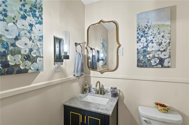1124 S Locust St, Ottawa, KS 66067 - half bathroom featuring vanity and toilet
