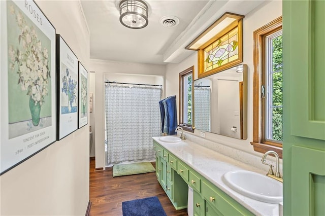 1124 S Locust St, Ottawa, KS 66067 - bathroom featuring healthy amount of natural light, double vanity, and wood finished floors