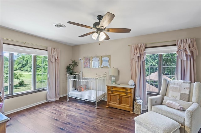 1124 S Locust St, Ottawa, KS 66067 - bedroom with multiple windows, dark wood-type flooring, and ceiling fan