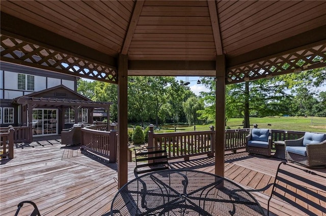 1124 S Locust St, Ottawa, KS 66067 - deck with a gazebo, outdoor dining space, and view of scattered trees