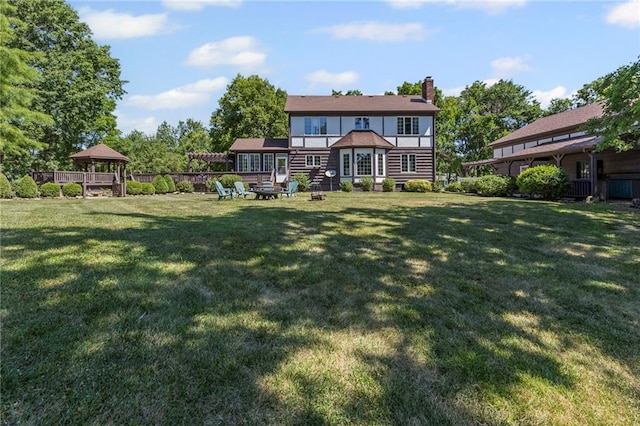 1124 S Locust St, Ottawa, KS 66067 - back of property with a gazebo, a chimney, and a yard