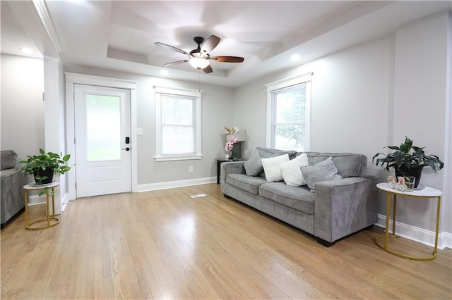 818 W 30th St, Independence, MO 64055 - living room with a raised ceiling, ceiling fan, light wood finished floors, and plenty of natural light