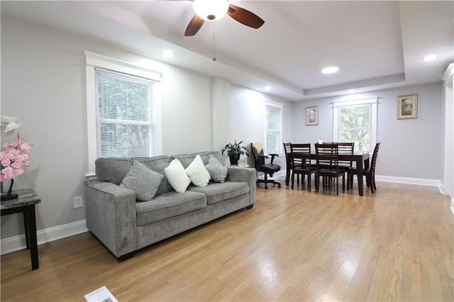 818 W 30th St, Independence, MO 64055 - living room with ceiling fan, light wood-style flooring, a tray ceiling, and recessed lighting