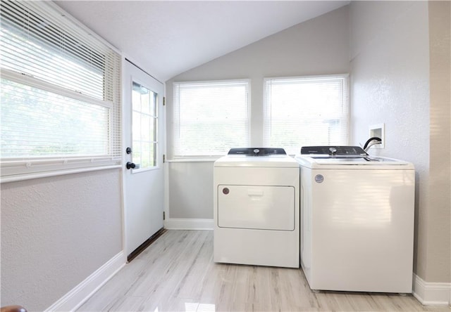 818 W 30th St, Independence, MO 64055 - laundry room with washer and dryer, light wood-type flooring, and a textured wall