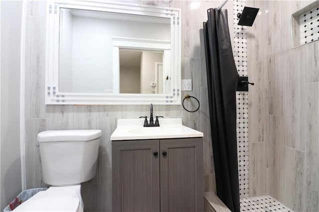 818 W 30th St, Independence, MO 64055 - full bathroom with tiled shower, vanity, and tile walls