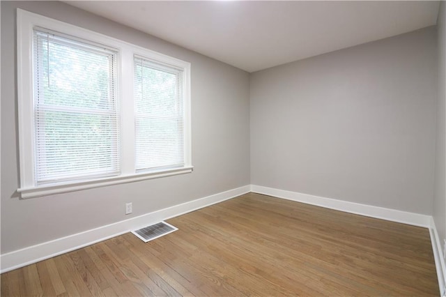 818 W 30th St, Independence, MO 64055 - unfurnished room featuring baseboards and light wood-style floors