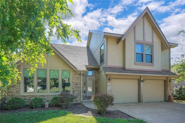 3945 N 123rd Ter, Kansas City, KS 66109 - tudor house featuring concrete driveway, an attached garage, a shingled roof, stucco siding, and brick siding