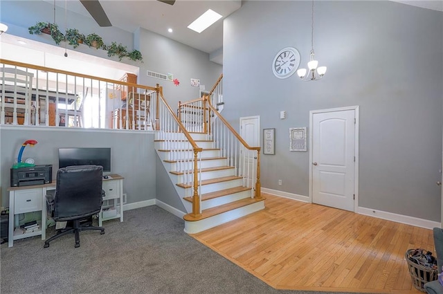 3945 N 123rd Ter, Kansas City, KS 66109 - office area featuring a towering ceiling, a chandelier, ceiling fan, and wood finished floors