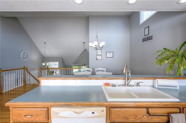 3945 N 123rd Ter, Kansas City, KS 66109 - kitchen with white dishwasher, a chandelier, and wood finished floors