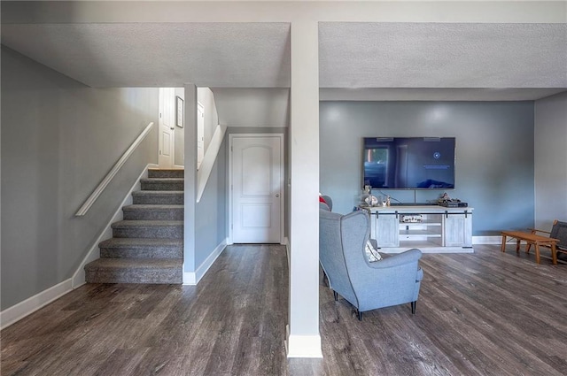 3945 N 123rd Ter, Kansas City, KS 66109 - living area featuring wood finished floors, stairs, and a textured ceiling