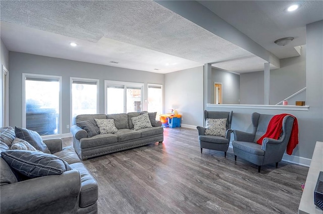 3945 N 123rd Ter, Kansas City, KS 66109 - living area featuring wood finished floors, healthy amount of natural light, a textured ceiling, and recessed lighting