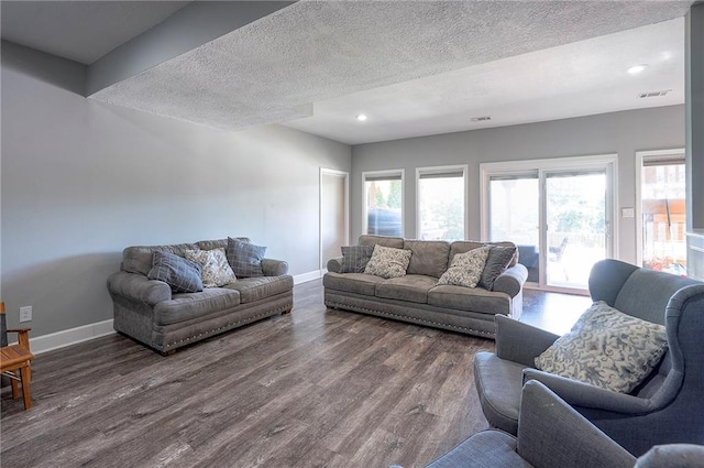 3945 N 123rd Ter, Kansas City, KS 66109 - living room featuring dark wood-style floors, healthy amount of natural light, recessed lighting, and a textured ceiling
