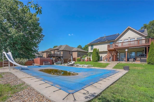 3945 N 123rd Ter, Kansas City, KS 66109 - view of swimming pool with a water slide, a wooden deck, stairway, a patio area, and a diving board
