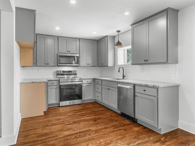 2832 Rushmore Ln, Saint Joseph, MO 64505 - kitchen with appliances with stainless steel finishes, gray cabinets, backsplash, recessed lighting, and dark wood-style flooring