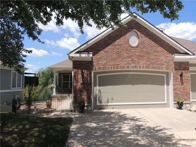 3722 S Bolger Ct, Independence, MO 64055 - view of front of home featuring driveway, brick siding, and an attached garage