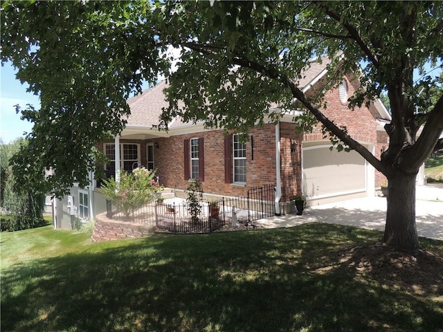 3722 S Bolger Ct, Independence, MO 64055 - view of property hidden behind natural elements featuring brick siding, an attached garage, and driveway