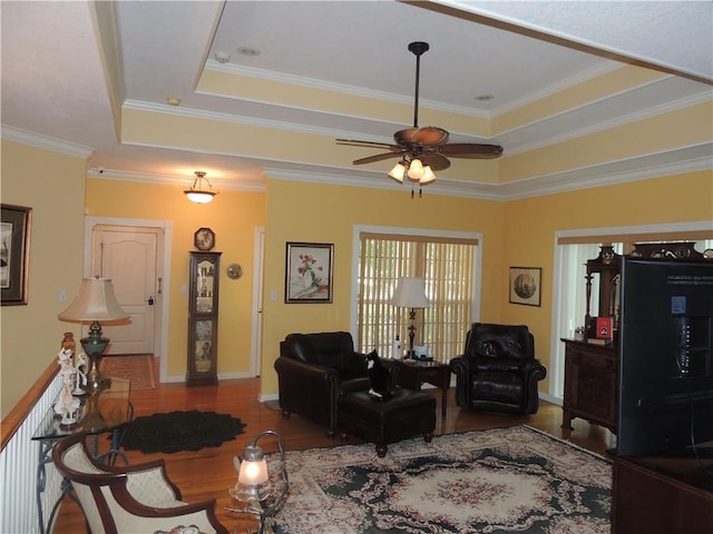 3722 S Bolger Ct, Independence, MO 64055 - living room featuring a tray ceiling, wood finished floors, ceiling fan, and crown molding