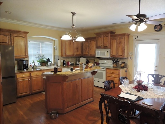 3722 S Bolger Ct, Independence, MO 64055 - kitchen with white appliances, decorative backsplash, a ceiling fan, a kitchen island, and brown cabinets