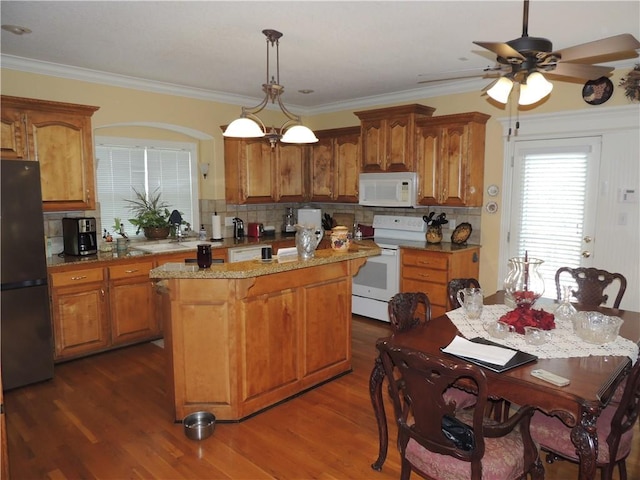 3722 S Bolger Ct, Independence, MO 64055 - kitchen featuring white appliances, a center island, decorative backsplash, dark wood finished floors, and a ceiling fan