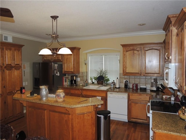 3722 S Bolger Ct, Independence, MO 64055 - kitchen with white appliances, brown cabinets, tasteful backsplash, dark wood-type flooring, and ornamental molding