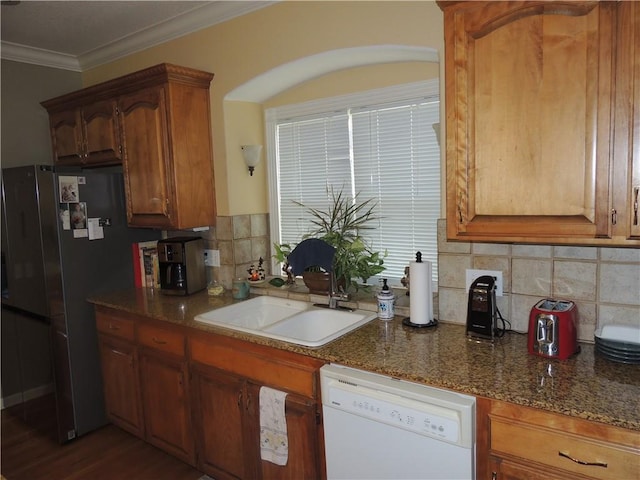 3722 S Bolger Ct, Independence, MO 64055 - kitchen with white dishwasher, ornamental molding, decorative backsplash, freestanding refrigerator, and brown cabinetry