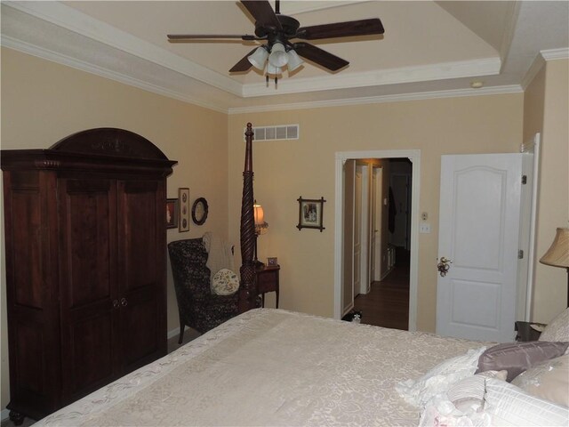 3722 S Bolger Ct, Independence, MO 64055 - bedroom featuring a raised ceiling, crown molding, wood finished floors, and ceiling fan