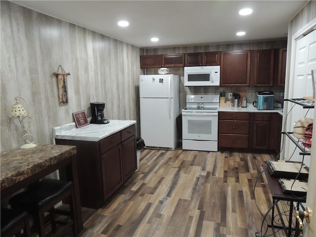 3722 S Bolger Ct, Independence, MO 64055 - kitchen featuring white appliances, wood finished floors, light countertops, and recessed lighting