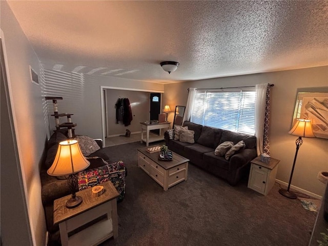 3335 N 54th St, Kansas City, KS 66104 - living room featuring a textured ceiling and dark carpet