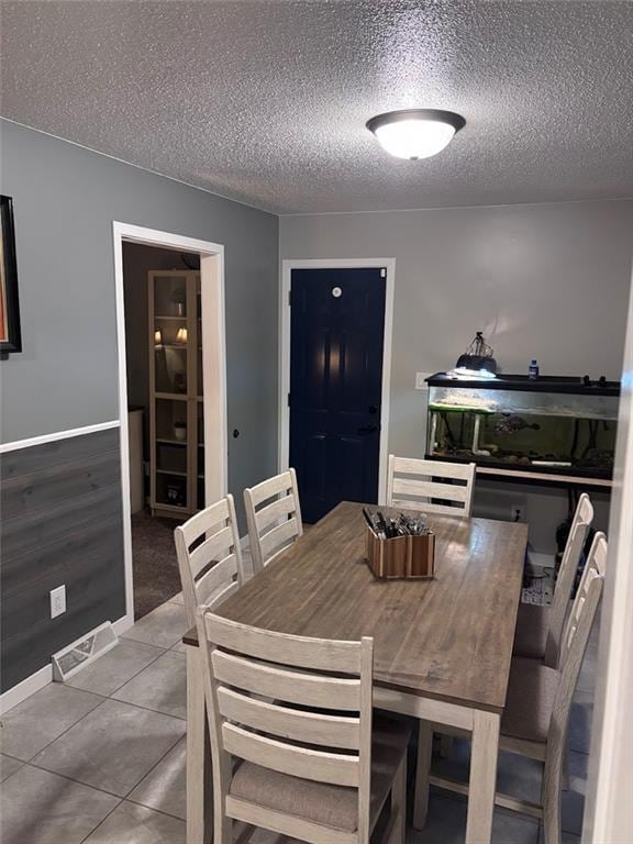 3335 N 54th St, Kansas City, KS 66104 - tiled dining room with a textured ceiling and baseboards