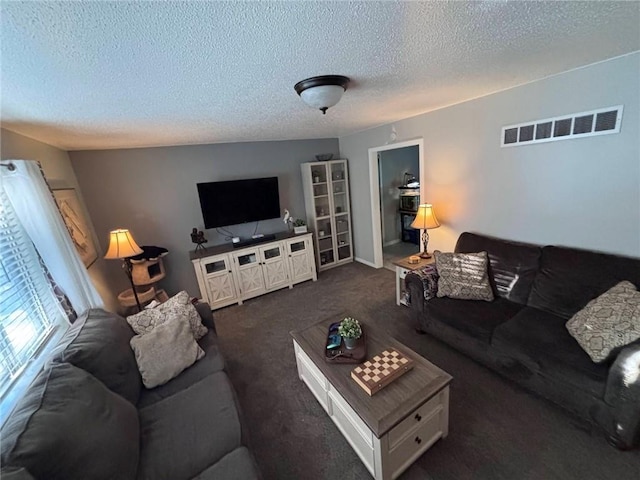 3335 N 54th St, Kansas City, KS 66104 - living area featuring a textured ceiling and dark carpet