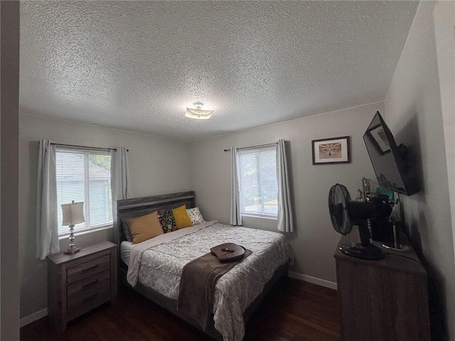 3335 N 54th St, Kansas City, KS 66104 - bedroom featuring multiple windows, dark wood finished floors, and a textured ceiling