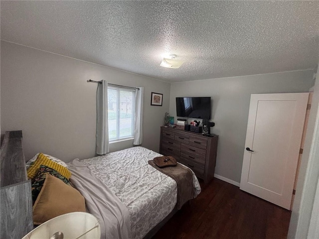 3335 N 54th St, Kansas City, KS 66104 - bedroom with dark wood-style flooring and a textured ceiling