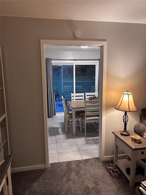 3335 N 54th St, Kansas City, KS 66104 - dining room with light carpet and light tile patterned floors