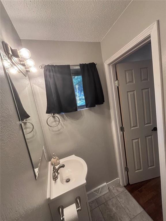 3335 N 54th St, Kansas City, KS 66104 - bathroom with a textured ceiling and vanity