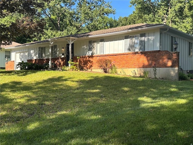 3335 N 54th St, Kansas City, KS 66104 - single story home featuring board and batten siding, brick siding, and a front yard