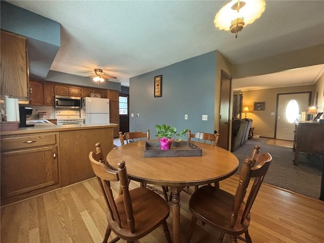 2425 Elephant Trl, Saint Joseph, MO 64506 - dining room featuring light wood finished floors and a ceiling fan