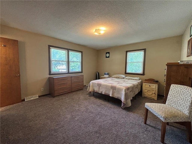 2425 Elephant Trl, Saint Joseph, MO 64506 - bedroom with a textured ceiling and dark carpet