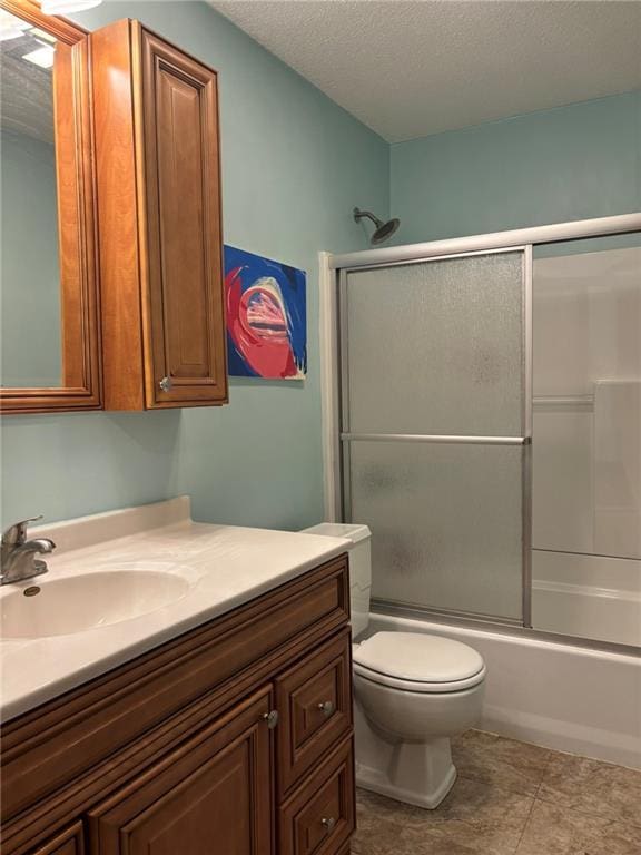2425 Elephant Trl, Saint Joseph, MO 64506 - full bathroom featuring vanity, shower / bath combination with glass door, tile patterned floors, and a textured ceiling