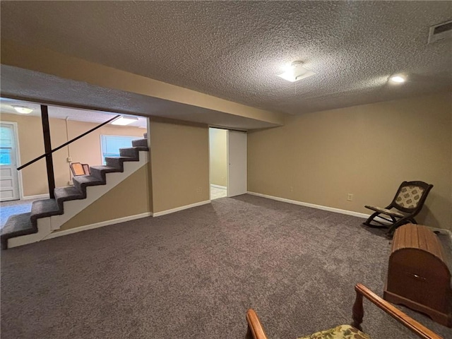 2425 Elephant Trl, Saint Joseph, MO 64506 - basement featuring a textured ceiling, carpet flooring, and stairs