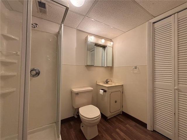 2425 Elephant Trl, Saint Joseph, MO 64506 - bathroom featuring wood finished floors, a shower stall, vanity, a closet, and a drop ceiling
